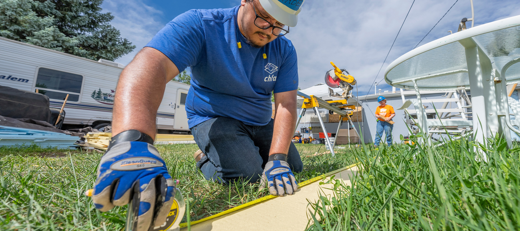 A man measuring a piece of siding