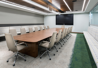 A large table with multiple chairs in a conference room